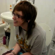 A girl wearing glasses has the longest shit of her life while sitting on the toilet. It just keeps coming out! Pay attention to the cute girl sitting on the edge of the tub. She starts cutting some farts, too! Great video!